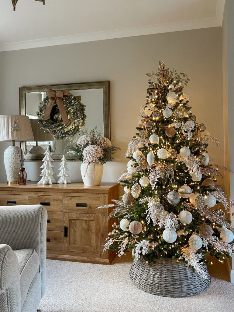 Decorated Christmas tree with white ornaments and lights in a cozy living room