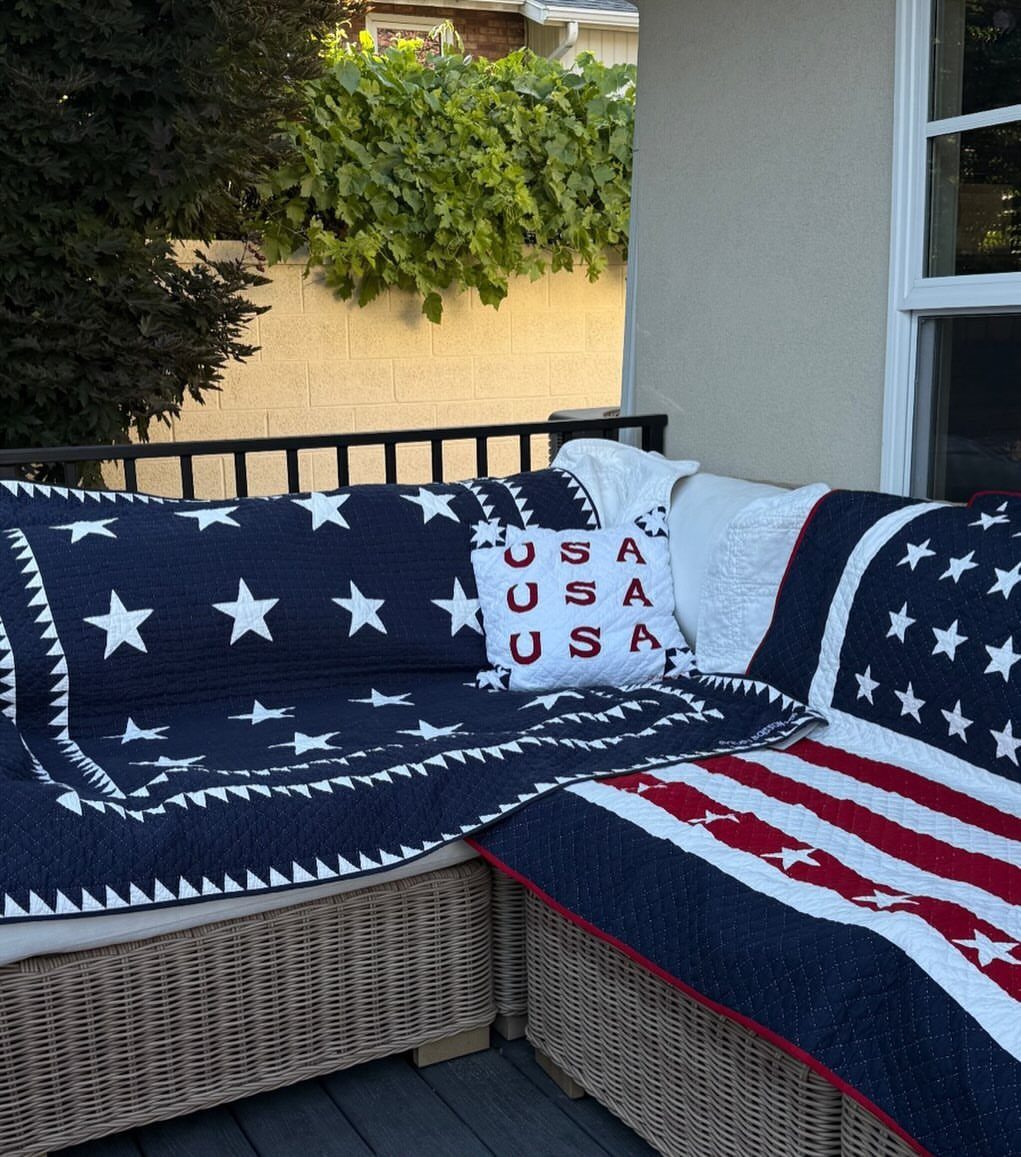 Patriotic outdoor sofa with star-patterned cushions and a USA printed throw pillow.