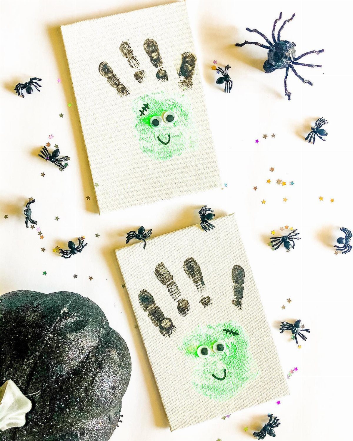 Two Frankenstein monster faces made from green handprints on small white canvases.