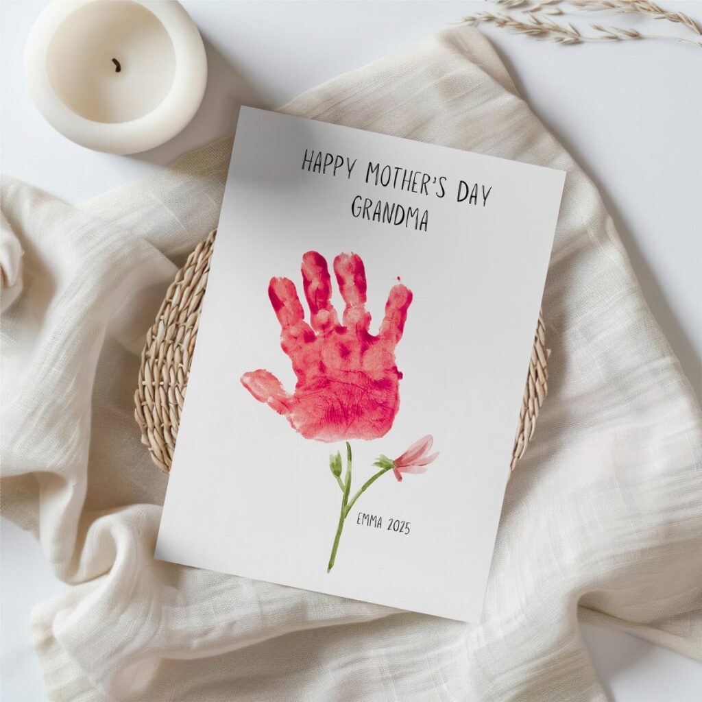 Handprint card for Mother's Day featuring a red handprint flower on white paper.