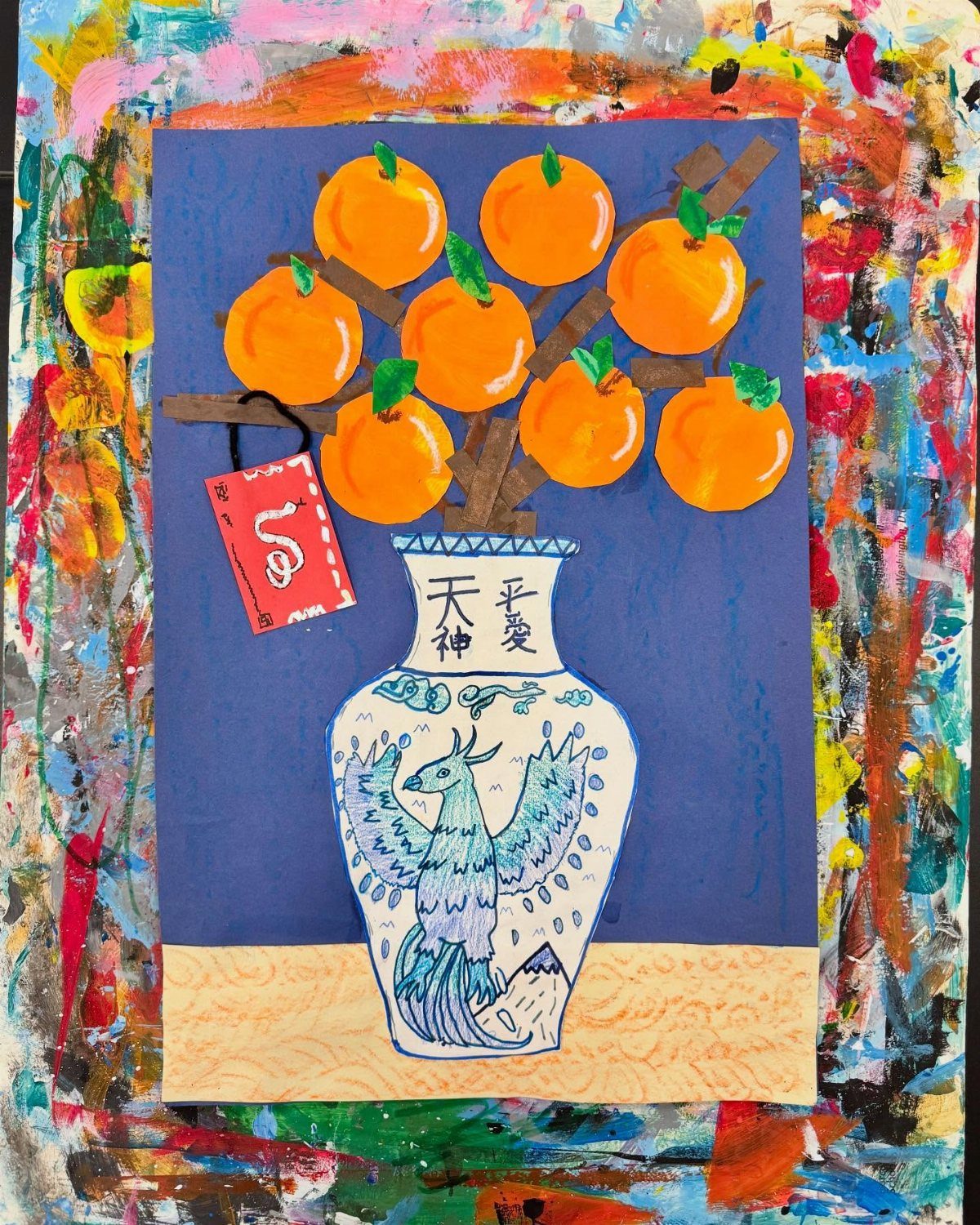 Mixed-media art of orange fruits in a white vase with a red envelope.