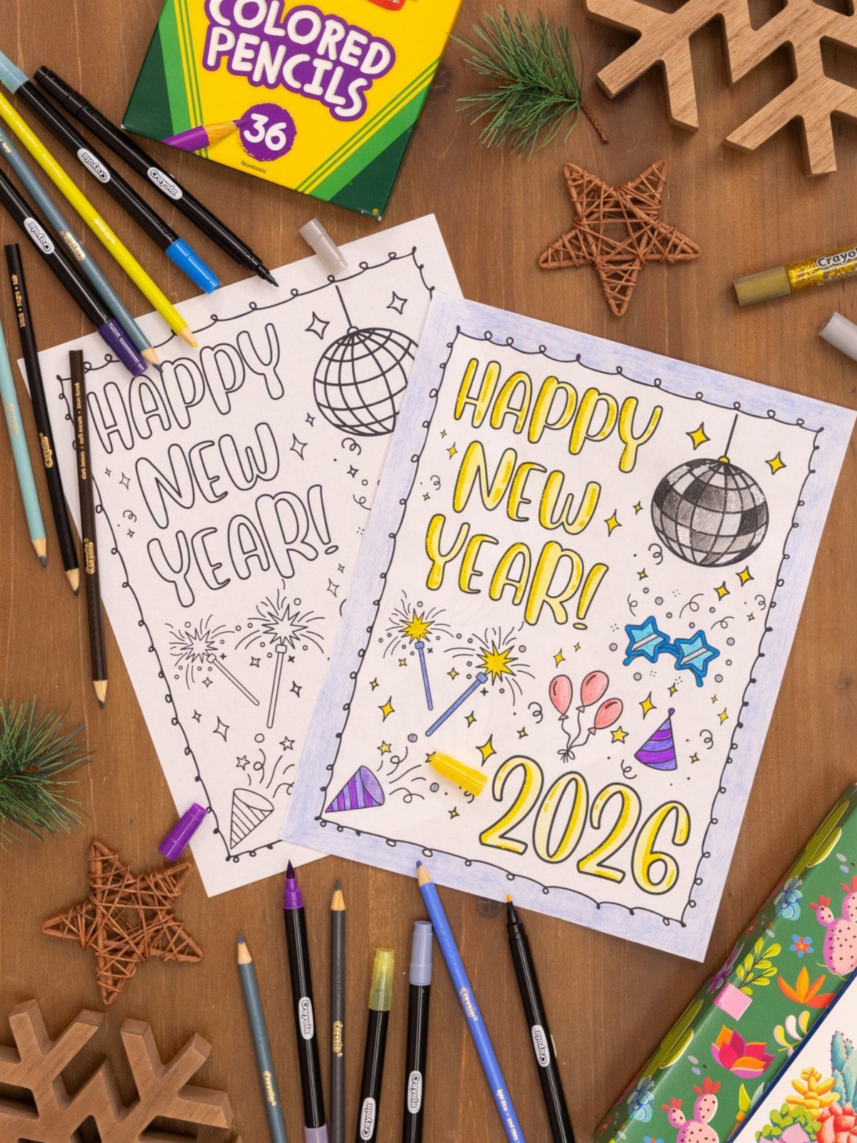 Two New Year coloring pages with 2026 text and disco balls on wooden table